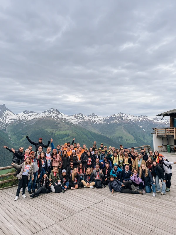 Large group together at a snowy mountain viewpoint