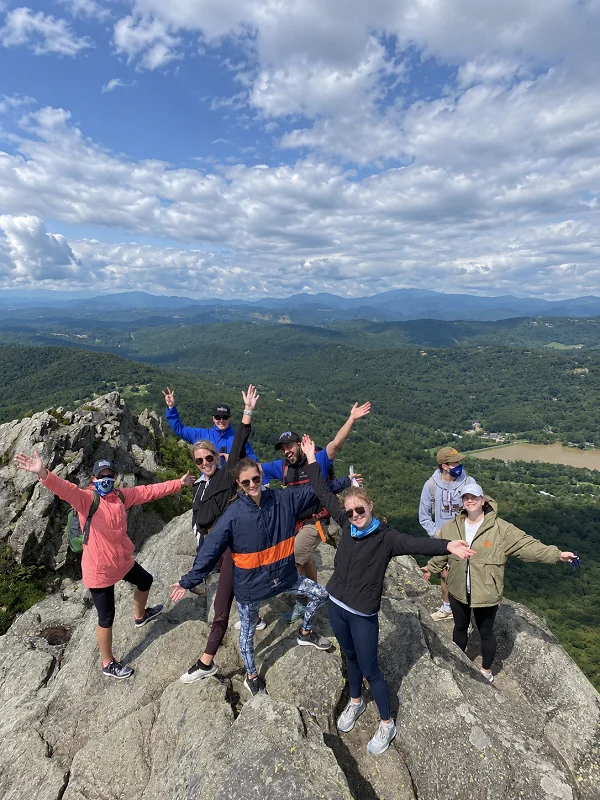 Friends celebrating together on a mountain summit