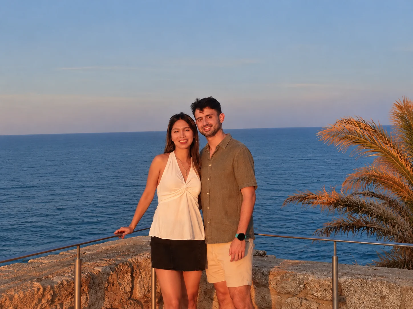 Couple enjoying a sunset by the sea