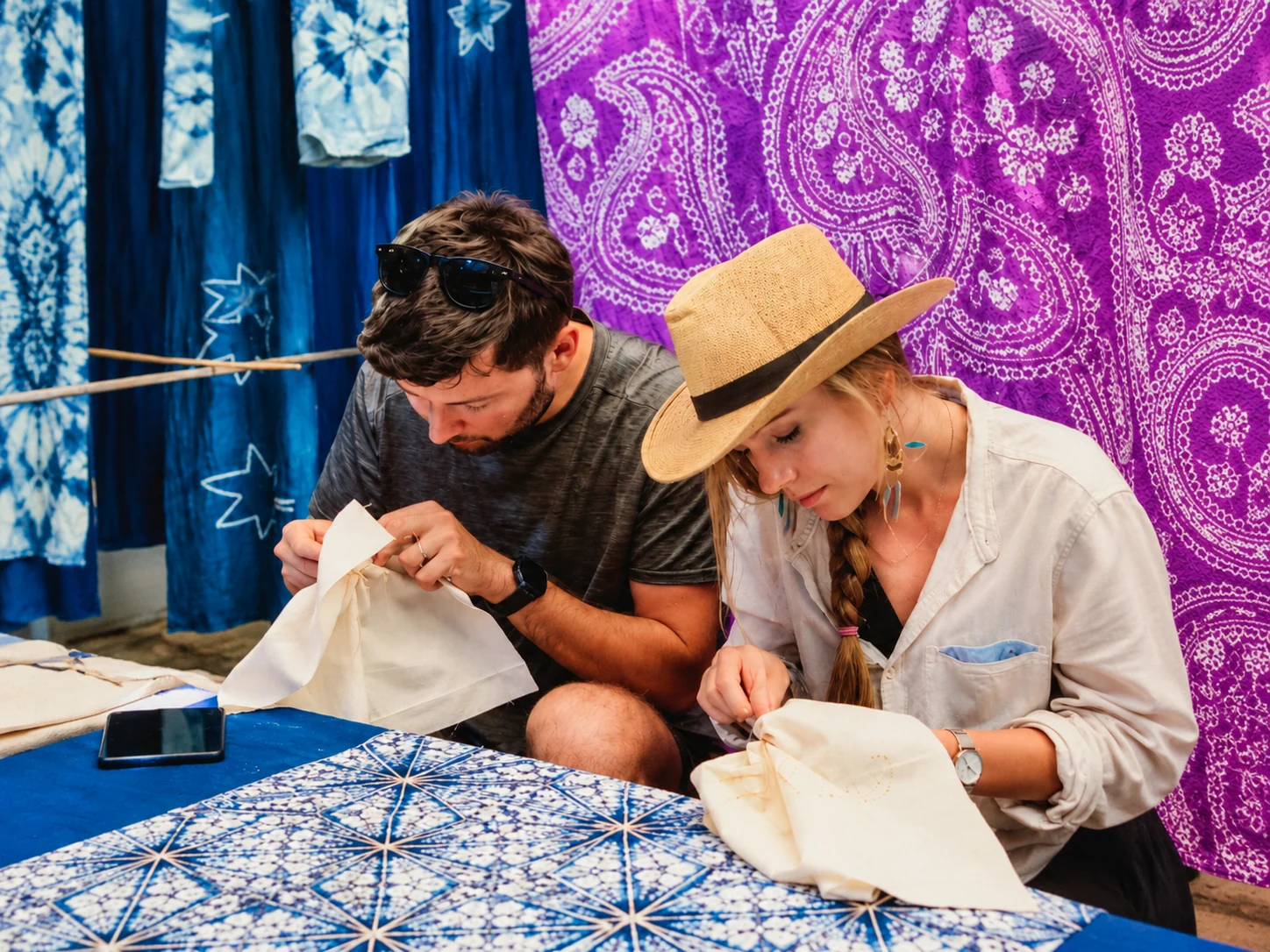 Travelers learning embroidery in a textile workshop