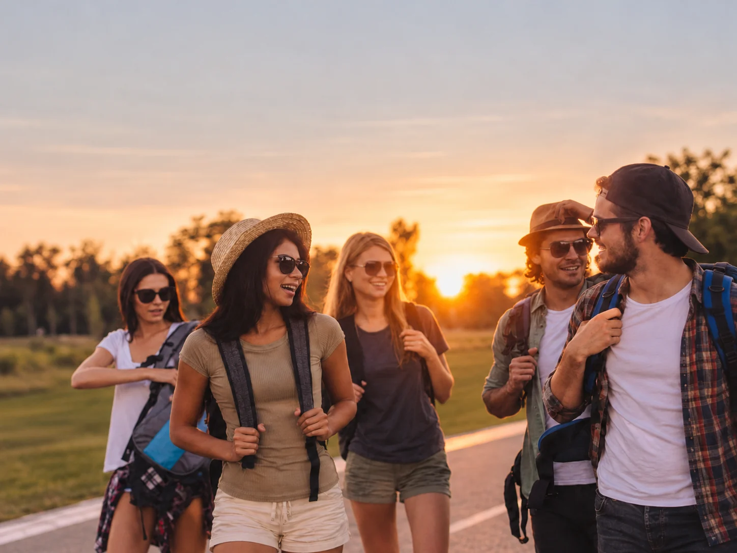 Young friends hiking together at sunset